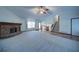Expansive living room featuring a brick fireplace, vaulted ceilings, and staircase to the second floor at 619 Stoney Creek Rd, Woodstock, GA 30188