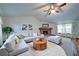 Bright living room featuring a vaulted ceiling, fireplace, neutral decor, and plush seating area at 619 Stoney Creek Rd, Woodstock, GA 30188