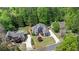 An aerial view shows the home's mature landscaping, large yard, and proximity to surrounding greenery at 1749 Patriots Nw Way, Kennesaw, GA 30152