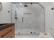 Shower room featuring marble-look walls, glass doors, and sleek black fixtures at 1749 Patriots Nw Way, Kennesaw, GA 30152
