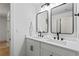 Modern bathroom with double sink vanity, black fixtures, and framed mirrors at 1749 Patriots Nw Way, Kennesaw, GA 30152