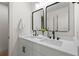 Modern bathroom featuring double sinks, sleek black fixtures, and a contemporary design at 1749 Patriots Nw Way, Kennesaw, GA 30152
