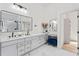 Elegant bathroom boasts double vanity, a make-up vanity, stylish lighting, marble floors, and an enclosed shower at 1749 Patriots Nw Way, Kennesaw, GA 30152