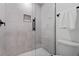 Bathroom featuring a tiled shower with glass doors and sleek black fixtures at 1749 Patriots Nw Way, Kennesaw, GA 30152