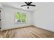Bright bedroom featuring hardwood floors, a ceiling fan, and a window with natural light at 1749 Patriots Nw Way, Kennesaw, GA 30152