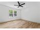 Bright bedroom featuring hardwood floors, a ceiling fan, and a window with natural light at 1749 Patriots Nw Way, Kennesaw, GA 30152
