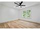 Bright bedroom featuring hardwood floors, a ceiling fan, and a window with natural light at 1749 Patriots Nw Way, Kennesaw, GA 30152