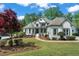 Charming two-story brick home with a well-manicured lawn and lush landscaping at 1749 Patriots Nw Way, Kennesaw, GA 30152