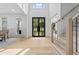 Bright foyer featuring soaring ceilings, hardwood floors, and black-framed glass front door at 1749 Patriots Nw Way, Kennesaw, GA 30152