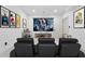 A spacious home theater featuring a large screen, comfortable seating, and stylish decor for an immersive experience at 1749 Patriots Nw Way, Kennesaw, GA 30152