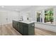 The kitchen features an eat-in island with quartz countertops and designer faucet at 1749 Patriots Nw Way, Kennesaw, GA 30152
