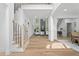 Open-concept living room with wood floors, high ceilings, modern staircase, and stylish decor at 1749 Patriots Nw Way, Kennesaw, GA 30152