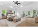 Stylishly furnished main bedroom features a seating area, hardwood floors, neutral color palette, and tray ceiling at 1749 Patriots Nw Way, Kennesaw, GA 30152