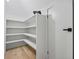 Bright pantry with white shelving and light hardwood flooring at 1749 Patriots Nw Way, Kennesaw, GA 30152