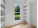 Walk-in closet with built-in shelving and a window, providing ample storage space and natural light at 1749 Patriots Nw Way, Kennesaw, GA 30152