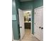 Bathroom with dark vanity, modern fixtures, and decorative accents seen through doorway at 2030 Hydrangea Ln, Austell, GA 30106