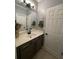Well-lit bathroom featuring a modern vanity, a decorative mirror, and stylish fixtures at 2030 Hydrangea Ln, Austell, GA 30106