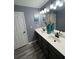 Modern bathroom with double sinks, vanity, mirrors, and contemporary lighting fixtures at 2030 Hydrangea Ln, Austell, GA 30106