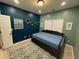 Cozy bedroom featuring blue accent walls, stylish decor, and plush rug for comfort at 2030 Hydrangea Ln, Austell, GA 30106