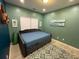 Comfortable bedroom with sage walls, a queen-sized bed, and natural light from the window at 2030 Hydrangea Ln, Austell, GA 30106