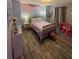 Charming bedroom with unique wall art, warm lighting, and hardwood floors at 2030 Hydrangea Ln, Austell, GA 30106