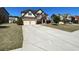 Two-story brick home features a two-car garage, landscaped yard, and a long concrete driveway at 2030 Hydrangea Ln, Austell, GA 30106