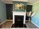 A cozy fireplace is framed by neutral paint and modern art hanging above at 2030 Hydrangea Ln, Austell, GA 30106
