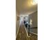 Hallway with dark wood floors and a staircase with black iron spindles at 2030 Hydrangea Ln, Austell, GA 30106