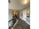 Upstairs hallway with dark wood floors and doors leading to bedrooms at 2030 Hydrangea Ln, Austell, GA 30106