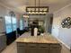Open kitchen with a large island, pendant lighting, and views into the living room at 2030 Hydrangea Ln, Austell, GA 30106