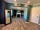 Open-concept living area with a fireplace, grey plank floor, and an airy feel at 2030 Hydrangea Ln, Austell, GA 30106