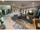 Spacious living room features a comfortable sofa, modern ceiling fan, and an open view to the kitchen at 2030 Hydrangea Ln, Austell, GA 30106