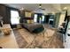 The bedroom has dark walls, tray ceilings, and views of the living area at 2030 Hydrangea Ln, Austell, GA 30106