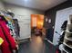 A customized walk-in closet featuring hanging clothes and view into adjoining room at 2030 Hydrangea Ln, Austell, GA 30106