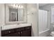 Bathroom with dark wood vanity, large mirror, and tub/shower combo at 2332 Leacroft Way, Marietta, GA 30062