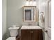 Powder room featuring wood vanity and square mirror at 2332 Leacroft Way, Marietta, GA 30062