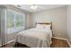 Neutral bedroom with a bed, window, and wood floors at 2332 Leacroft Way, Marietta, GA 30062