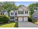 Charming two-story home with a well-manicured lawn and a two-car garage at 2332 Leacroft Way, Marietta, GA 30062