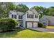 Charming two-story home with a well-manicured lawn and a two-car garage at 2332 Leacroft Way, Marietta, GA 30062