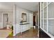 Inviting foyer with hardwood floors, a decorative table and mirror, and an open doorway at 2332 Leacroft Way, Marietta, GA 30062