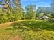 Expansive backyard features a lush lawn with a gazebo and mature trees at 294 Farm Ridge Ne Dr, Woodstock, GA 30188