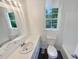 Clean bathroom features a bright window, white vanity, and modern fixtures at 294 Farm Ridge Ne Dr, Woodstock, GA 30188