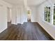 Bright bedroom boasts natural light from large windows and neutral walls to complement dark wood-look flooring at 294 Farm Ridge Ne Dr, Woodstock, GA 30188