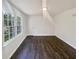 Bright bedroom features large windows, fresh paint, and modern, dark-toned hardwood floors at 294 Farm Ridge Ne Dr, Woodstock, GA 30188