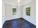 A bright bedroom with vinyl flooring, a light, and natural light from windows and white walls at 294 Farm Ridge Ne Dr, Woodstock, GA 30188