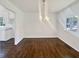 Bright dining room with dark hardwood floors and access to the kitchen with a chandelier at 294 Farm Ridge Ne Dr, Woodstock, GA 30188