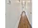 Clean, bright hallway features wood-look flooring, fresh white paint, and updated electrical, connecting various rooms at 294 Farm Ridge Ne Dr, Woodstock, GA 30188