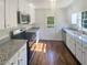 Well-lit kitchen with modern appliances, granite counters, and stylish cabinetry at 294 Farm Ridge Ne Dr, Woodstock, GA 30188