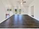 Spacious, light-filled living room with sleek dark wood flooring and neutral paint at 294 Farm Ridge Ne Dr, Woodstock, GA 30188