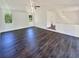 This is a living room with a ceiling fan and a hardwood floor and natural light from multiple windows at 294 Farm Ridge Ne Dr, Woodstock, GA 30188